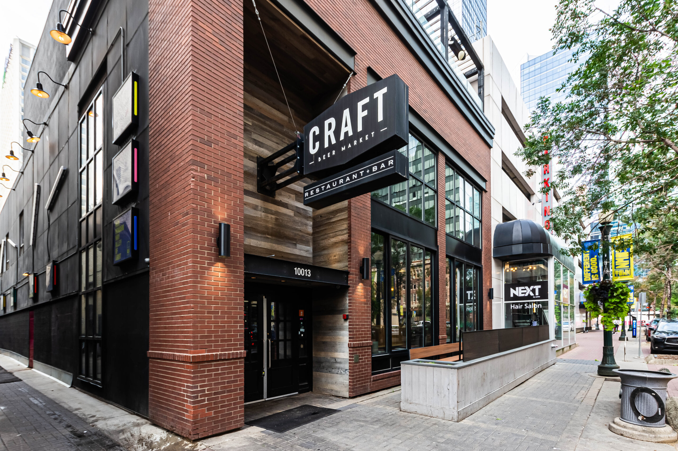 CRAFT Beer Market Street view of the exterior of CRAFT Beer Market restaurant and bar, with large signage, brick and wood facade, glass windows, and social vibes perfect for enjoying craft beer and rotational taps on a lively city sidewalk.